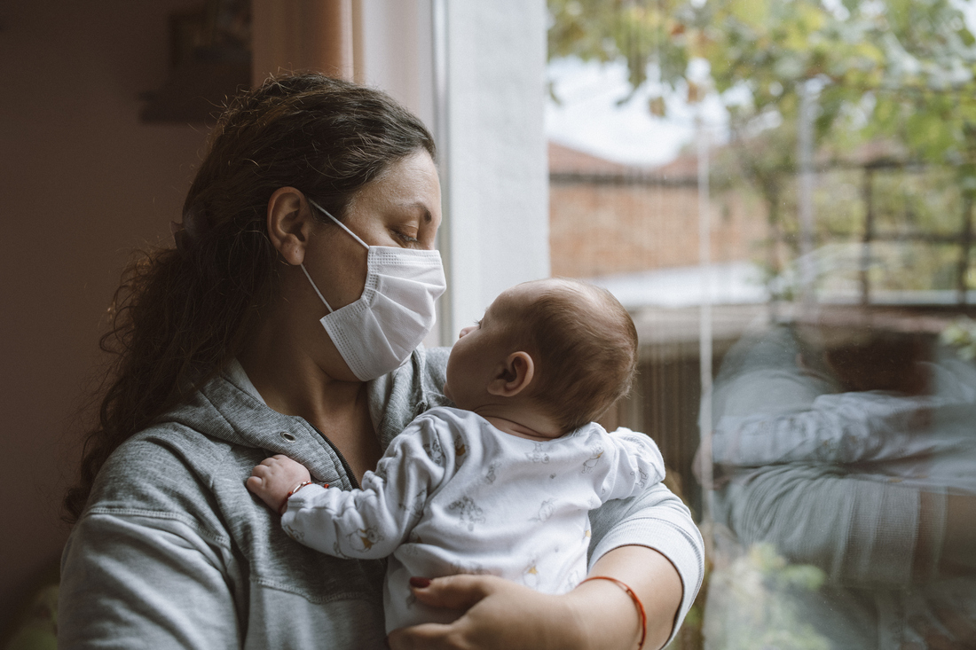 Masked mother with baby