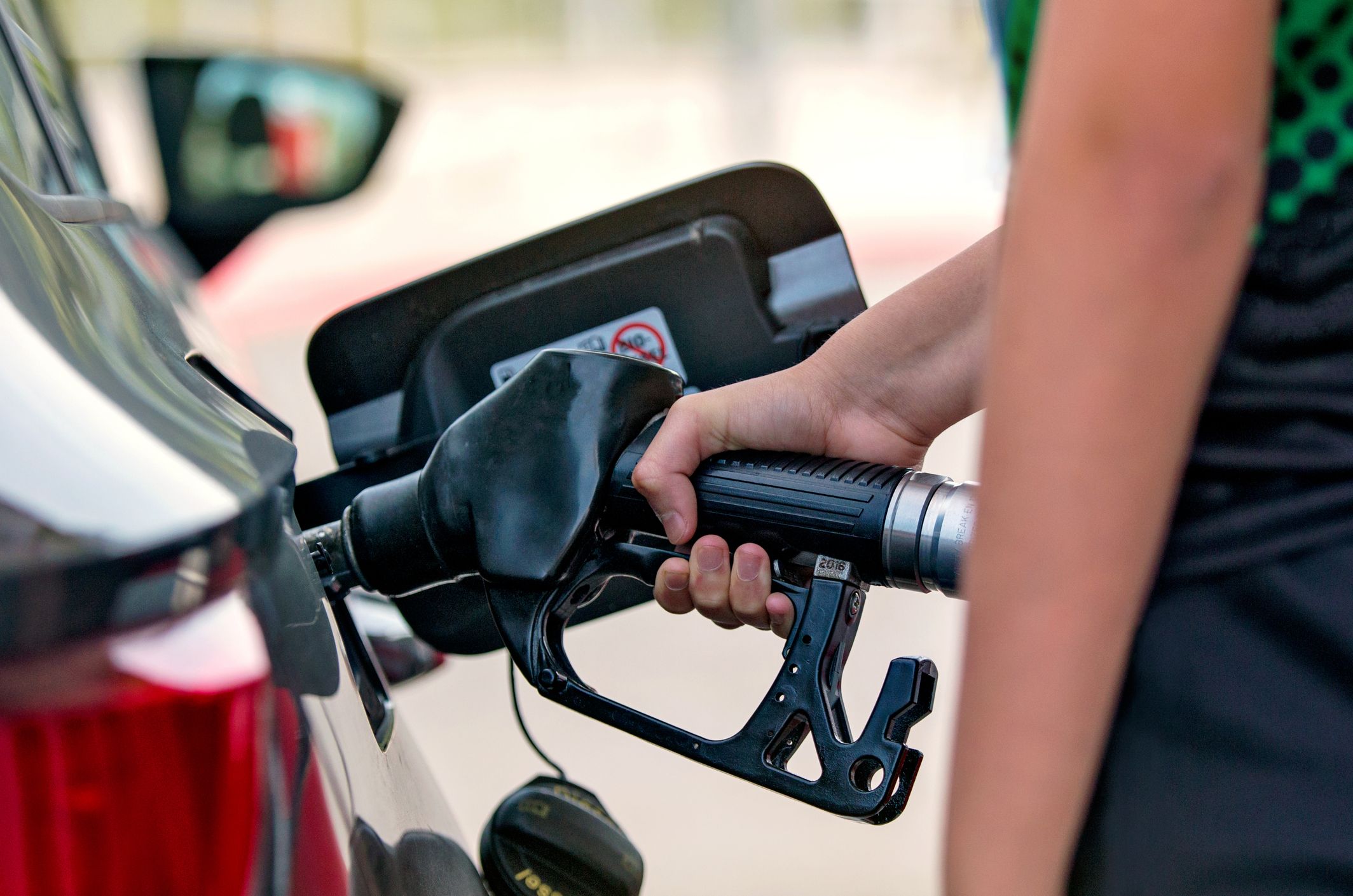 close-up-of-a-hand-pouring-fuel-into-a-car-royalty-free-image-1584165892