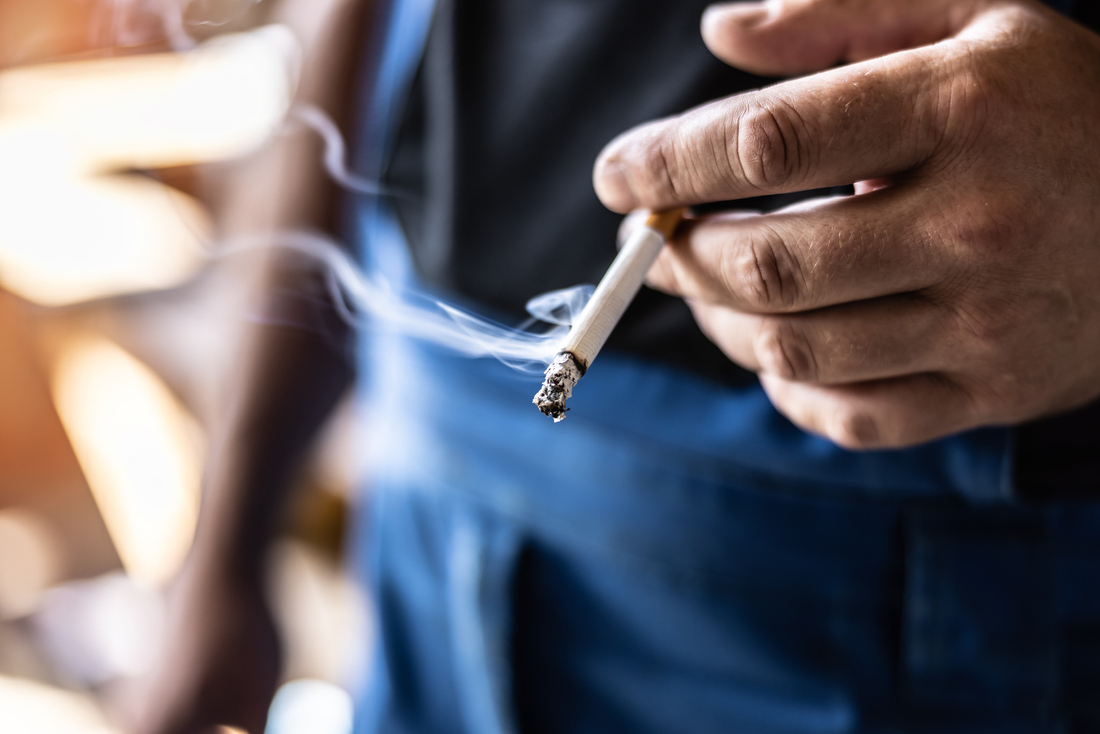 Man holding cigarette smoking