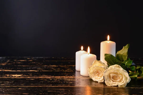 depositphotos_254548242-stock-photo-burning-candles-and-flowers-on