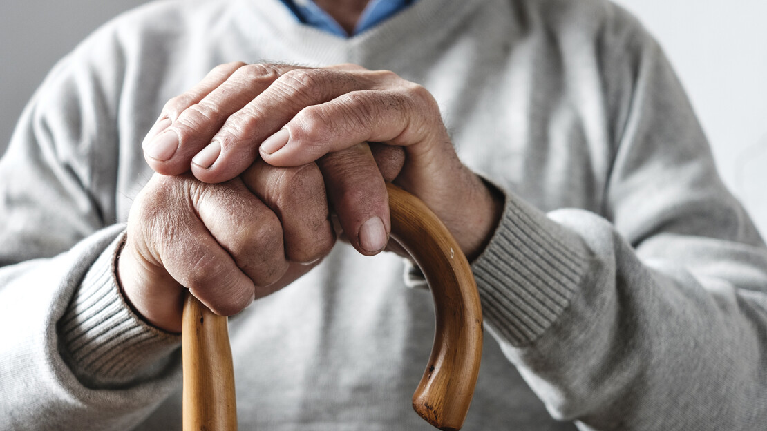 hands-elderly-man-resting-walking-cane-1110x624